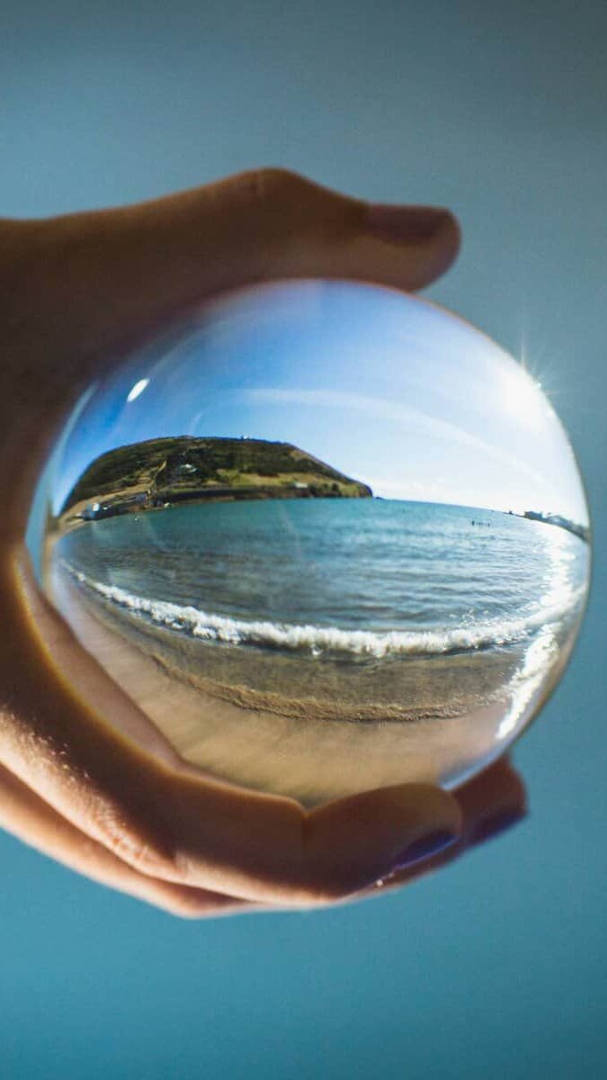 A look through a glass ball refracting a close up shot of the beach on Faial