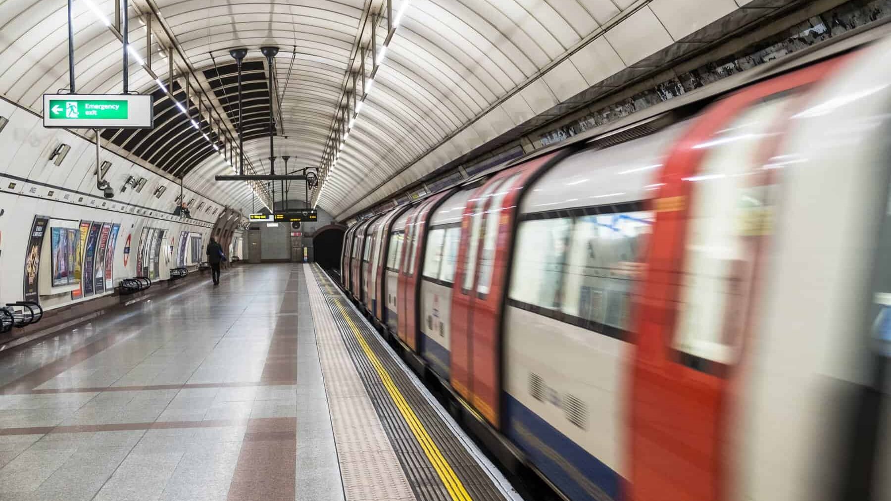 Una fotografía en movimiento del metro de Londres saliendo de una estación.